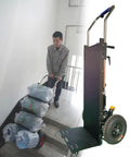 User operates Super Heavy Duty Electric Stair Climber Hand Truck Dolly With 400 Kg Load Capacity on stairs, lifting heavy items.