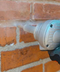 Fast Mortar Joint Cleaner Tool With 8mm Carbide Cutter for Brick and Masonry in use on brick wall, close-up view