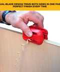 Quad Pro Pneumatic Edge Trimmer With Tungsten Carbide Blades Trims From One Half Inch To One And One Quarter Inch No Springs Attached Trims All Directions Ultra Smooth Action Red Finish shown trimming wood edge smoothly by hand.