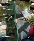 Lawn Aerator Shoes With Spikes For Heavy Duty Yard Work Four Adjustable Straps For Easy Secure Fit shown on a foot in a garden.