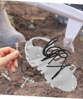 Pro Grade Lawn Aerator Shoes Spikes Kit with heavy duty metal pegs and laces on soil for grass aeration and soil revitalization
