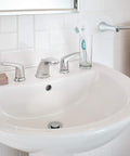 Colony Pro 8 Inch Widespread Two-Handle Low Arc Bathroom Faucet With Pop-Up Drain Assembly 1.2 GPM Polished Chrome on white sink