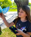Child holding Rad Flying RC Bird Toy For Kids With Realistic Flapping Wings And USB Recharge 2.4GHz Remote Control Outdoor