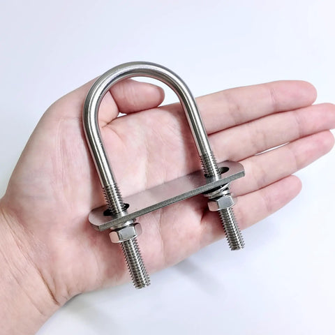 Hand holding Four Set M8 Stainless Steel U Bolts Kit With Nuts Washers And Plate 40mm Wide 90mm Long 304 Grade U Bolts