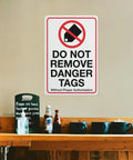 Industrial Grade Aluminum Safety Sign 8x12 Inch No Tampering Lockout Caution Plaque on wall above counter.