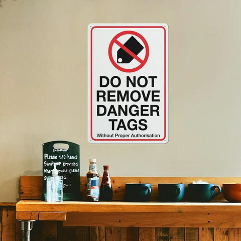 Industrial Grade Aluminum Safety Sign 8x12 Inch No Tampering Lockout Caution Plaque on wall above counter.