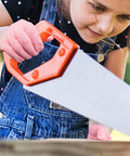 Child wearing Kids Cut Resistant Gloves Level 5 Protection For Cooking Wood Carving Whittling Gardening And DIY Projects Food Grade Safe Small Size For Ages 4-6 Years Pink Green Or Gray using a saw.