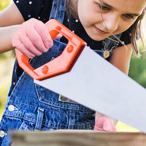 Child wearing Kids Cut Resistant Gloves Level 5 Protection For Cooking Wood Carving Whittling Gardening And DIY Projects Food Grade Safe Small Size For Ages 4-6 Years Pink Green Or Gray using a saw.