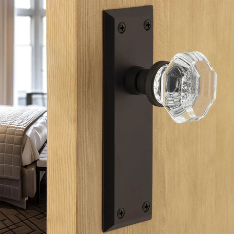 Crystal Door Knob With Plate In New York And Waldorf Style Vintage Glass Knob Set on wooden door, black backplate visible.