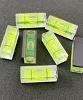 Six Pack Mini Magnetic Bubble Level Kit Sleek Acrylic Build With Neon Vials Always Dead On For Quick Measurements on black background.