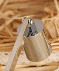 Close-up of Bad Boy Stainless Steel Candle Snuffer With Super Long Handle and Slick Silver Plating in a decorative setting.