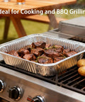 Forty Pack Disposable 9x13 Aluminum Foil Pans Deep Half Size Steam Table Trays on BBQ with cooked meat visible
