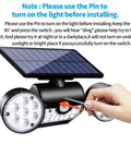 Hand using a pin to activate Beefed Up Outdoor Solar Security Lights 30 LED Dual Head Motion Sensor, IP65 waterproof, adjustable wall light.