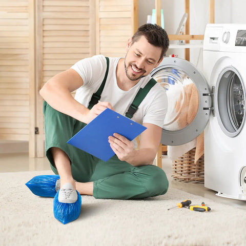 Man wearing Disposable Shoe Covers Large Pack 100 Count Waterproof Non Slip Bootie Covers fixing a washing machine indoor