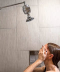 Person using High Output Shower Filter Cartridge for sensitive skin and dry scalp, softening hard water, improving hair and skin health