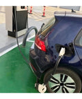 Heavy Duty Ccs2 To Ccs1 Ev Charging Adapter 200A Connector in use on a blue electric vehicle at a charging station.