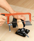 Person using hacksaw with 4 inch 360 Degree Rotating Bench Vise With Quick Release Ratchet Wrench on wood, ideal for woodworking and metalworking.