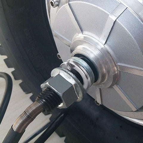 Spring lock washer on stainless steel bolt with hex nut attached to metal housing.