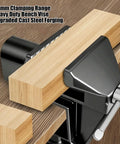 Close-up of Heavy Duty Mini Work Bench Vise With Adjustable Quick Release Clamp holding wood, showcasing 50mm clamping range.