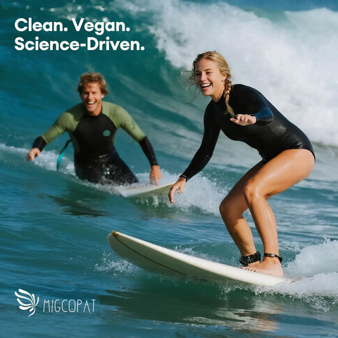 Two people surfing on waves with clean vegan science-driven branding visible in the background.