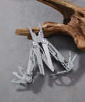 All In One Multitool Pliers With Replaceable Wire Cutters And Spring Loaded Action shown open with various tools extended