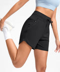 Side view of Women's 5 Inch Athletic Running Shorts With Quick-Dry Stretch, High Waist, 3 Pockets in black, bent leg pose.
