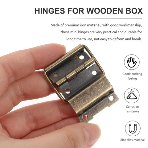Hand holding a retro-style hinge from 30Pcs Mini Iron Hinges For Jewelry Boxes And Small Wooden Cases Rust Resistant Hardware