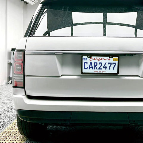 Rear view of vehicle with 2-Pack Matte Black License Plate Frames, Rust-Proof Aluminum 12.25 x 6.25 Inch, Narrow Border Keeps State Labels Visible.