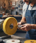 Person using Heavy Duty Six Inch Cotton Buffing Wheels For Bench Grinders Two Pack on a workbench for polishing metal.