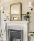 Gold Fabric Shade Wall Sconce Set of 2 with brass lamps and black back plate mounted above a fireplace, luxe urban glow decor.