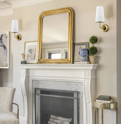 Gold Fabric Shade Wall Sconce Set of 2 with brass lamps and black back plate mounted above a fireplace, luxe urban glow decor.