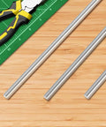 Three Eighths Inch By Eight Inch 304 Stainless Steel Rod Smooth Round Solid Shaft For DIYers Crafts Metalworking And Hobby Builds Rust Resistant Durable 2 Pack next to ruler and pliers on wooden surface