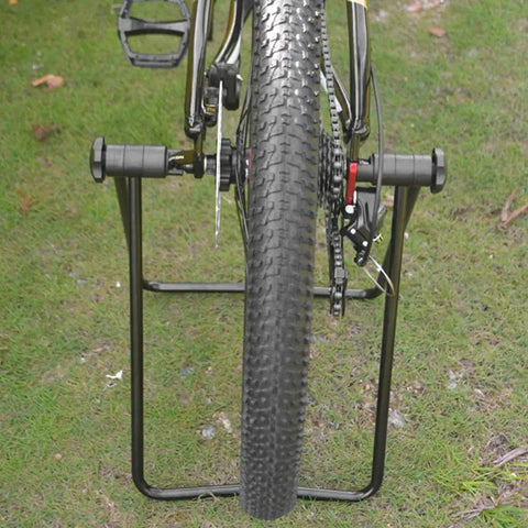 Rear view of bike mounted on Aluminum Bike Trainer Stand With Storage Rack For Mountain Road And Folding Bikes Adjustable Repair Stand Durable Rust Proof Maintenance Station For Home Garage And Workshop Area.