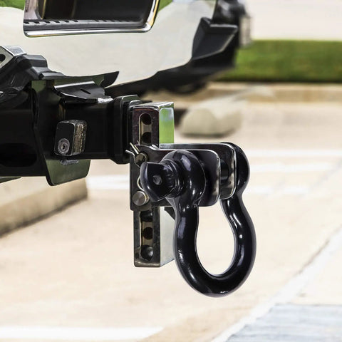 Damn Tough D Ring Shackles 3 4 Inch Beefy Forged Steel Towing Hardware 2 Pack With Safety Pin attached to truck hitch.