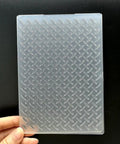 Flat Out Dope 3D Plastic Embossing Folder Template With Absolutely Stunning Industrial Wind Texture For A6 Card Making And Total Game Changer Diy Scrapbook Craft Projects, showing raised diamond pattern in hand.