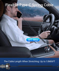 Heavy Duty Usb C Car Charger With Six Foot Coiled Cable And Smart Power Switch To Halt Battery Drain While You Rapidly Juice Up Phones Smoothly On Every Daily Commute in a car, with a man using his phone.