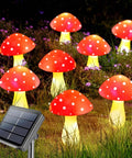 8 Pack Red Mushroom Solar Lights For Outdoor Garden Decor With 8 Lighting Modes, festive vibe illuminating grass and purple flowers.
