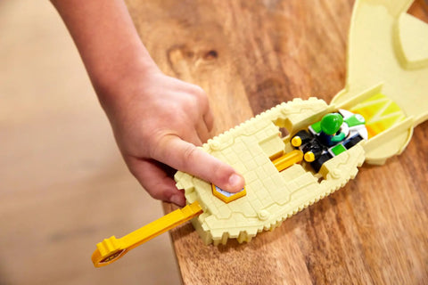 Child's hand using pull back launcher with Luigi die cast kart from Hot Wheels Mario Kart Thwomp Ruins Track Set With Luigi Die Cast Kart And Pull Back Launcher Piranha Plant Slide Playset For Kids Kid Approved Fun Racing Toy Car Gift For Fans Of Mario Kart Video Games.