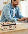 Raptor Inspired Kids Lunch Bag Insulated Tote With Red Tailed Hawk Design on table, man working in background