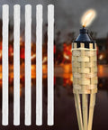 5 Pack Replacement Wicks For Tiki Torches And Oil Lamps Built To Last Premium Long Life Fiberglass Torch Wicks displayed next to a lit tiki torch outdoors