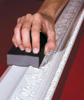 Hand using Pro Grade Sanding Sponges Pack Three By Five By One Inch Medium And Fine Grit for contours on detailed molding surface