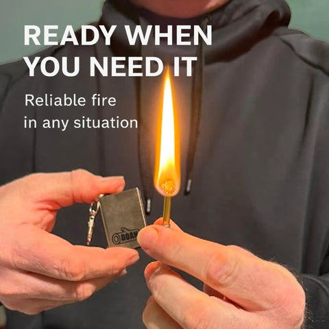 Lit Refillable Survival Fire Starter Keychain Tool For Camping And Hiking in use, showing flame and metal design