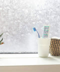 Self Adhesive Privacy Glass Window Film For Windows Doors Showers And Glass Surfaces Seventeen By Seventy Eight Inch Roll No Sweat Easy Peel And Stick With Adjustable Privacy Levels For Any Space installed on window with toiletries on sill