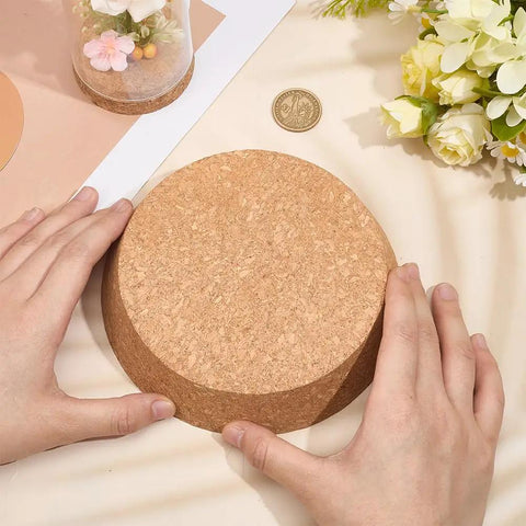 Hands holding a large cork stopper, showing the Two Pack Large Cork Stoppers For Bottles And Jars 5 To 6 Inch Tapered Wood Bottle Lids.