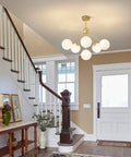Six Light Frosted White Glass Globe Sputnik Chandelier in Modern Gold Finish for a Lit Statement Flush Mount Ceiling Light in Foyer
