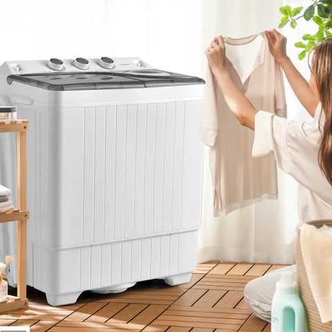 Compact Twin Tub Portable Washing Machine With Separate Wash And Spin Dryer Dual Timer Knobs Auto Drain Pump Fits Any Small Room Light Grey White in use with a person holding a shirt.