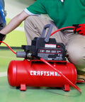 2 Gallon Portable Air Compressor With Knockout Oil Free Motor Delivering A Steady 125 Psi used for inflating a tire.