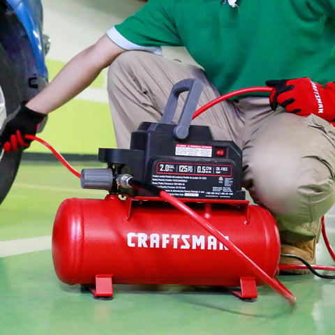 2 Gallon Portable Air Compressor With Knockout Oil Free Motor Delivering A Steady 125 Psi used for inflating a tire.