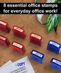 Top Tier Self Inking Office Stamp Set With Eight Gotta Have Rubber Phrases Like Paid And Approved arranged on a desk.