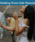 Garden hose with blue color and solid brass fittings being used outdoors, water spraying from nozzle.